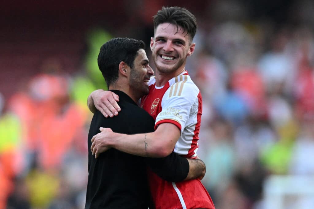 Arsenal's English midfielder #41 Declan Rice (R) celebrates with Arsenal's Spanish manager Mikel Arteta (L) on the pitch after the English Premier League football match between Arsenal and Manchester United at the Emirates Stadium in London on September 3, 2023. 