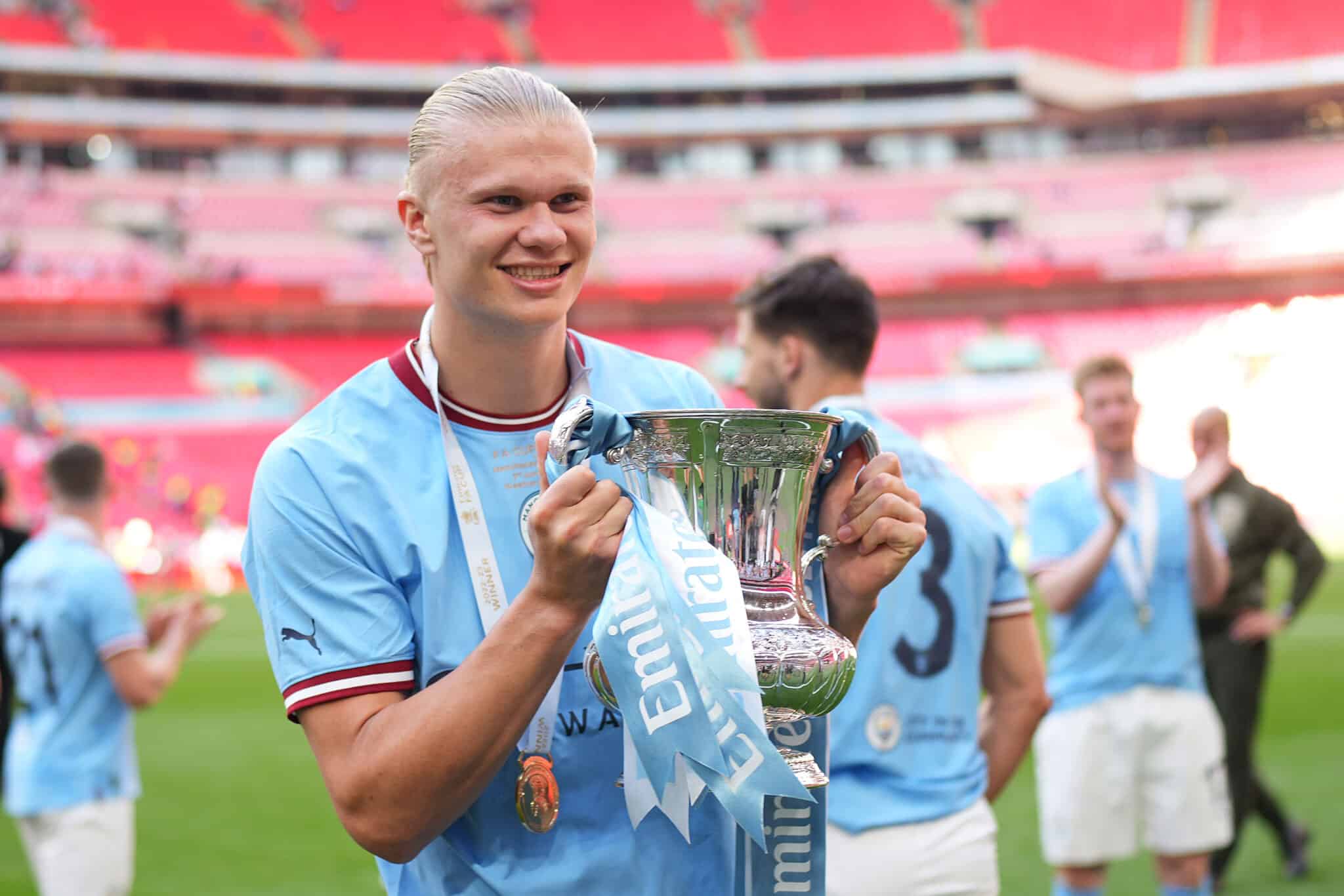 Erling Haaland of Manchester City celebrates with the FA Cup Trophy after the team's victory during the Emirates FA Cup Final between City and Manchester United at Wembley Stadium. if he plays in the FA Cup semi-finals, he'll be looking to strike gold.