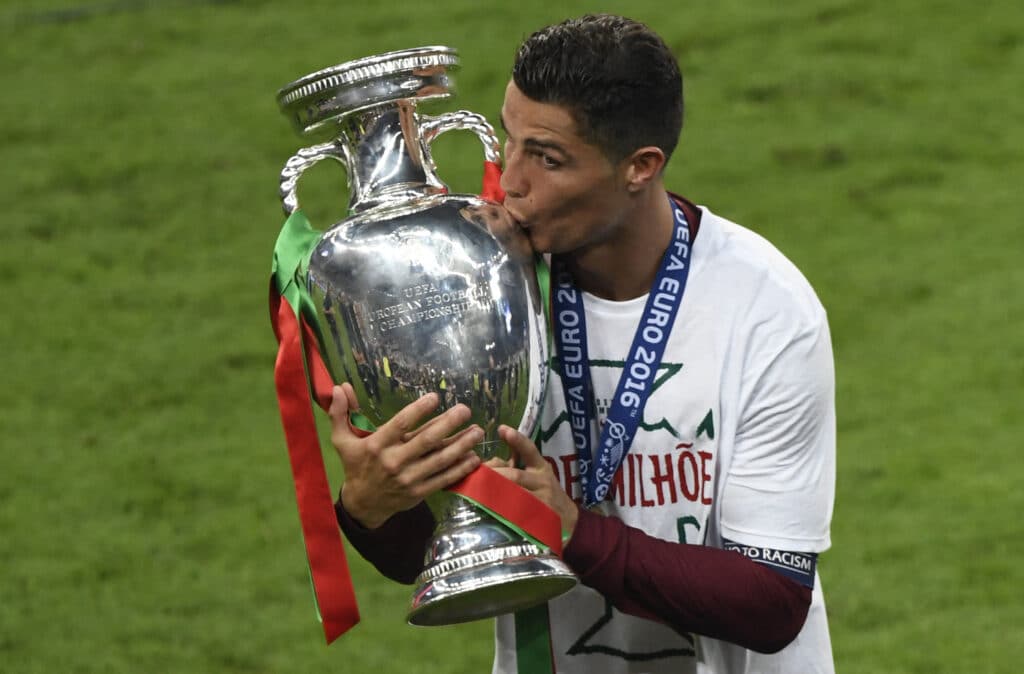 Portugal's forward Cristiano Ronaldo kisses the trophy after the team's 1-0 win in the Euro 2016 final football match between Portugal and France at the Stade de France in Saint-Denis, north of Paris, on July 10, 2016. 