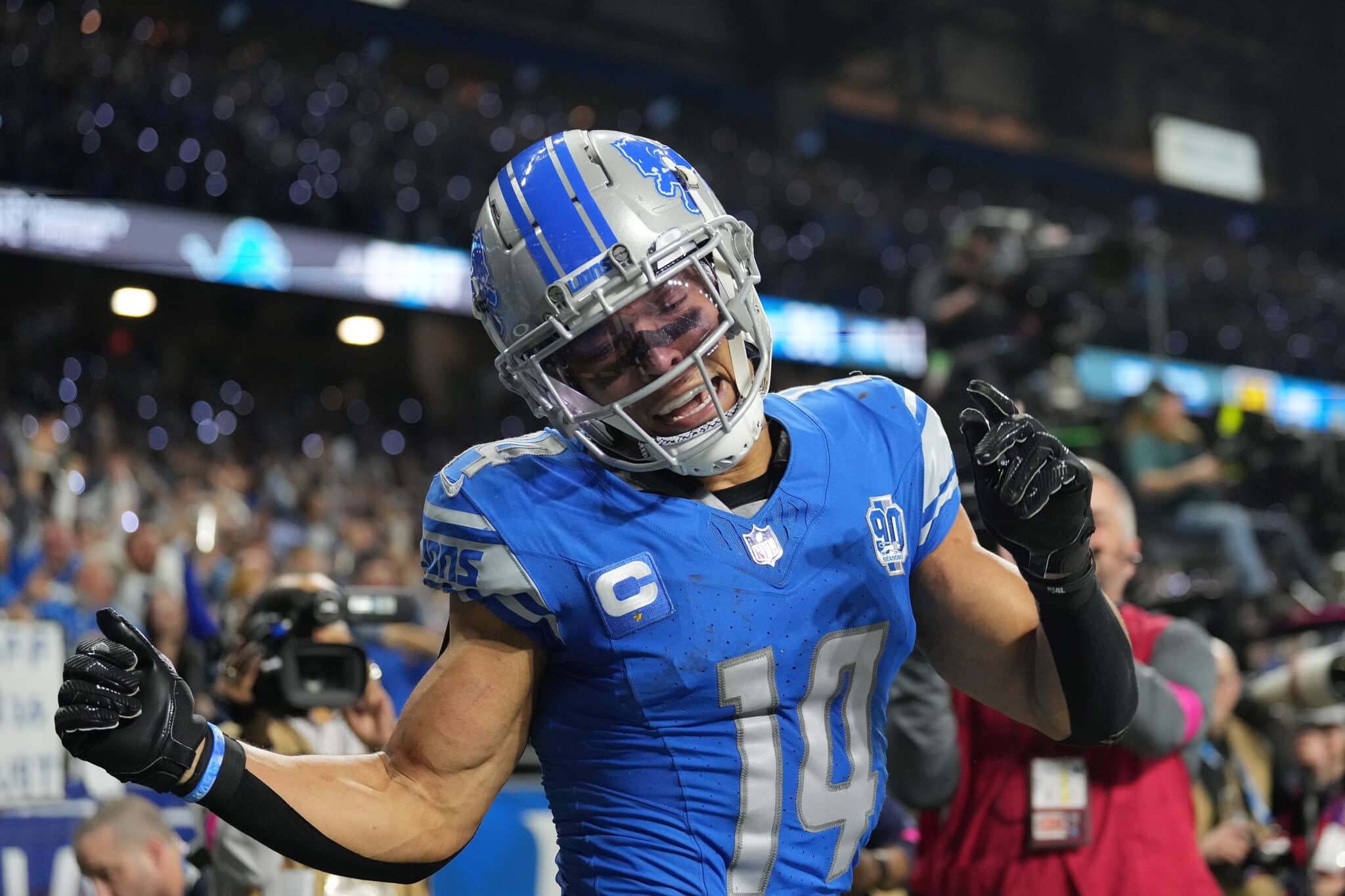 DETROIT, MICHIGAN - JANUARY 21: Amon-Ra St. Brown #14 of the Detroit Lions celebrates a touchdown against the Tampa Bay Buccaneers during the fourth quarter of the NFC Divisional Playoff game at Ford Field on January 21, 2024 in Detroit, Michigan.