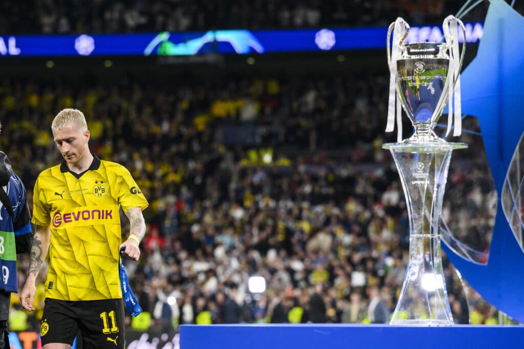 Dortmund's Marco Reus walks past the UEFA Champions League trophy after the award ceremony, disappointed. 