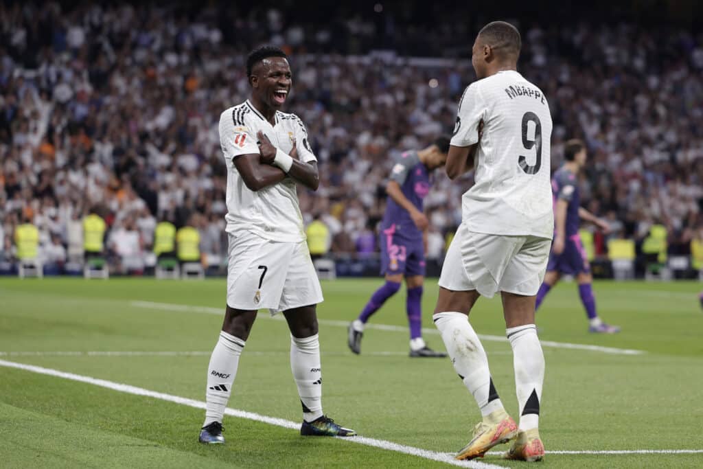 Vinicius Junior of Real Madrid celebrates with his teammate Kylian Mbappe